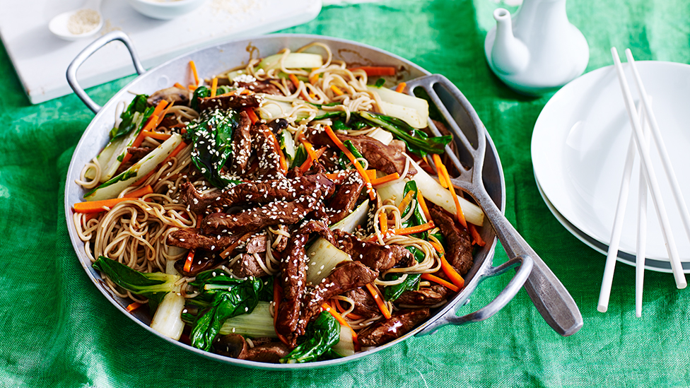 Beef, vegetable and soba noodle stir fry in a wok