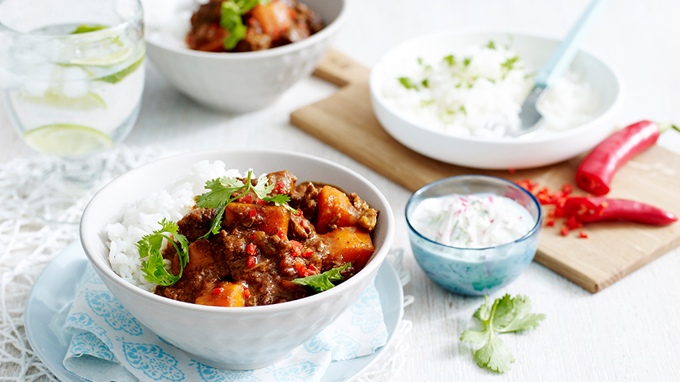 A bowl of beef and sweet potato vindaloo curry with rice