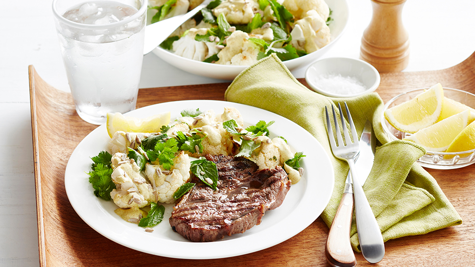 Steak on a plate with a curried cauliflower salad