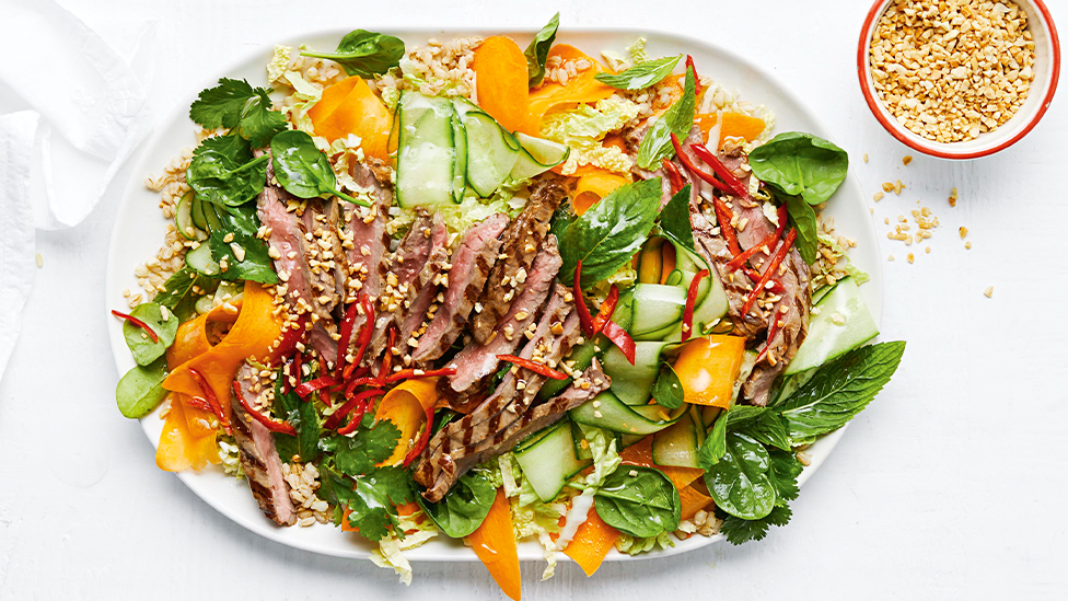 A salad of pearl barley, wombok, cucumber and carrot ribbons, and steak