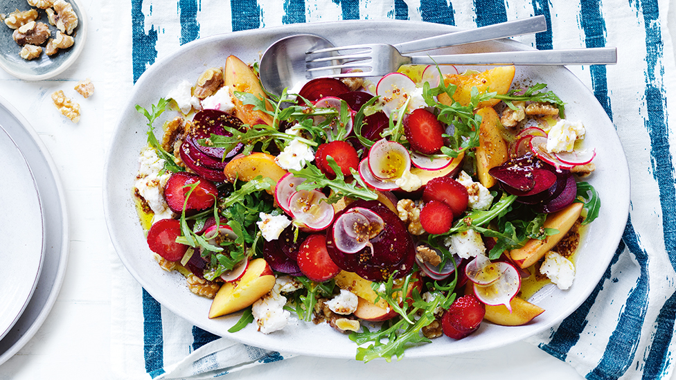 Beetroot, peach and walnut salad on a serving plate