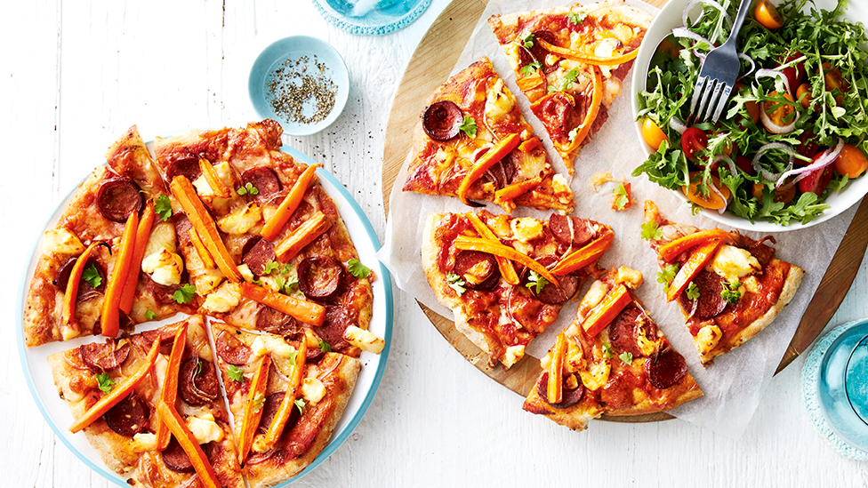 Chorizo and carrot pizza with rocket salad
