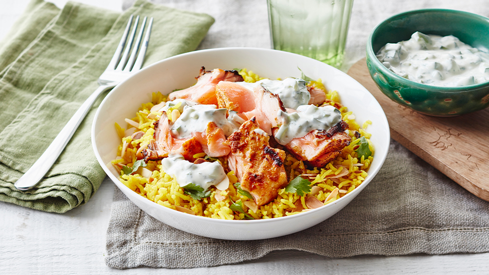 Curried salmon with turmeric rice and raita