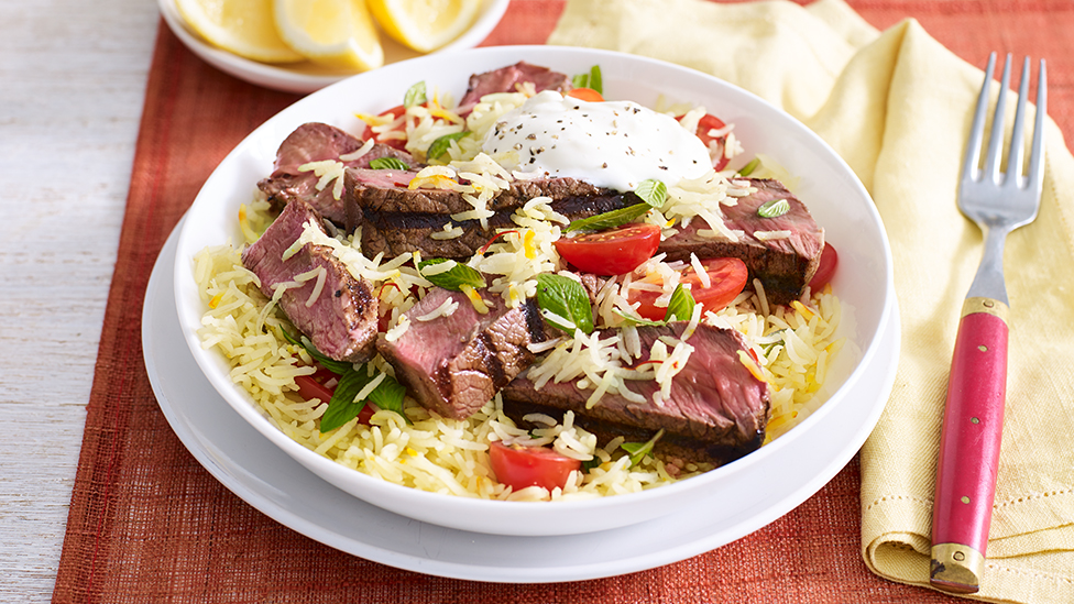 Bowl of garam masala beef with saffron, mint and tomato rice