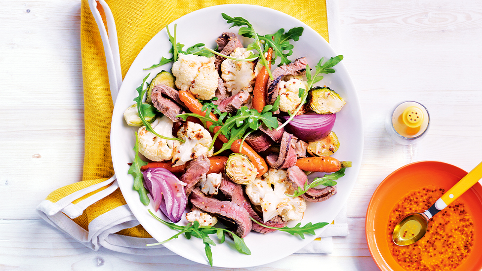 Sliced horseradish beef with a salad of rocket with cauliflower, brussels sprouts and carrots