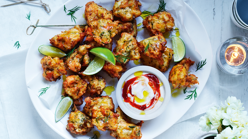 Hot-Smoked Salmon and Potato Fritters on a serving plate with a yoghurt dipping sauce