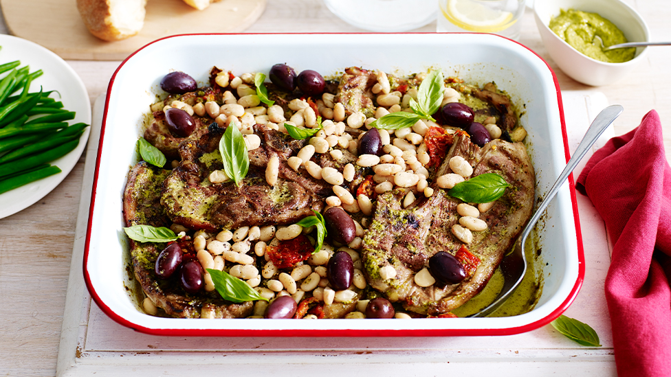 Lamb tray bake with pesto, tomatoes and olives