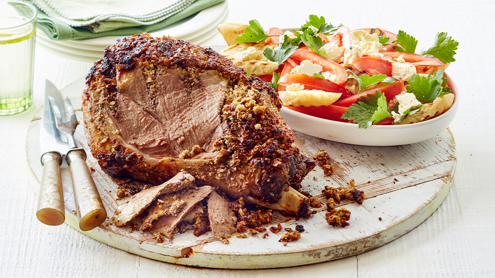 Orange hazelnut-crusted lamb leg with tomato bread salad