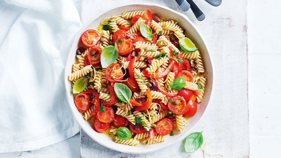 Pasta salad with tomatoes, olives and basil