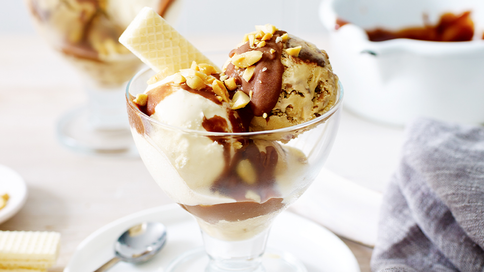 Peanut butter ice-cream sundae with warm chocolate fudge sauce