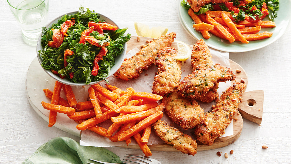 Pine nut crusted chicken with warm kale salad