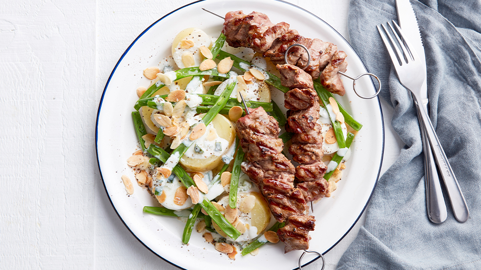 Potato and bean salad with lamb skewers