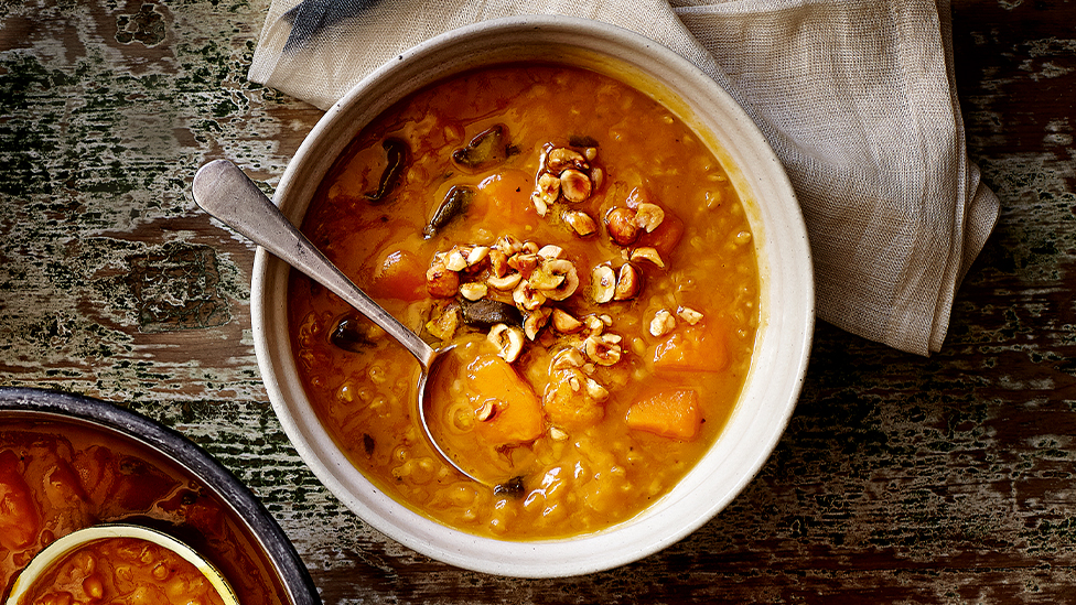 Pumpkin and barley soup with crushed hazelnuts