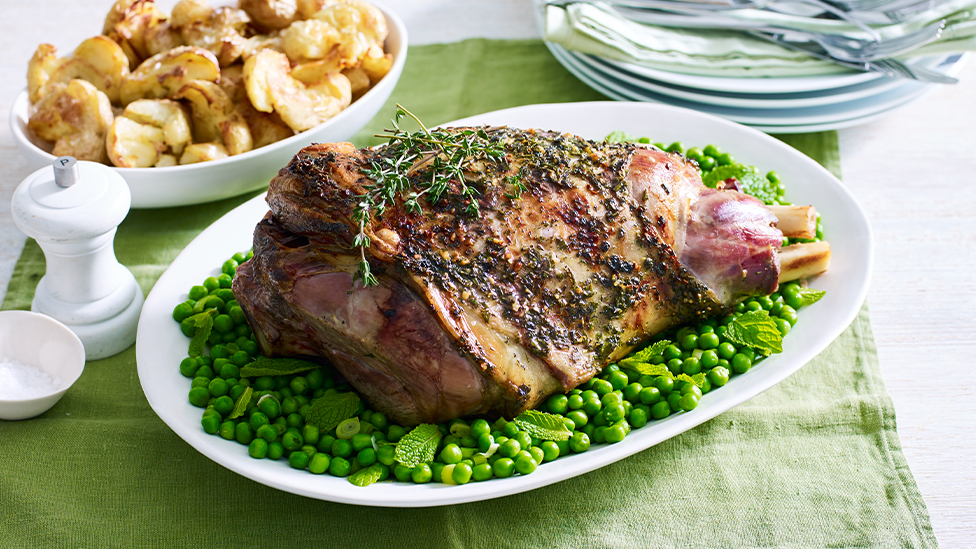 Roast lamb with herb butter, smashed potatoes and minted peas