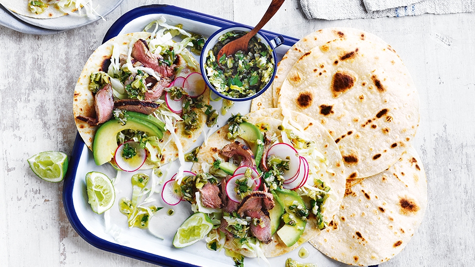 Curtis Stone's steak tacos with spring onions and pepita salsa verde