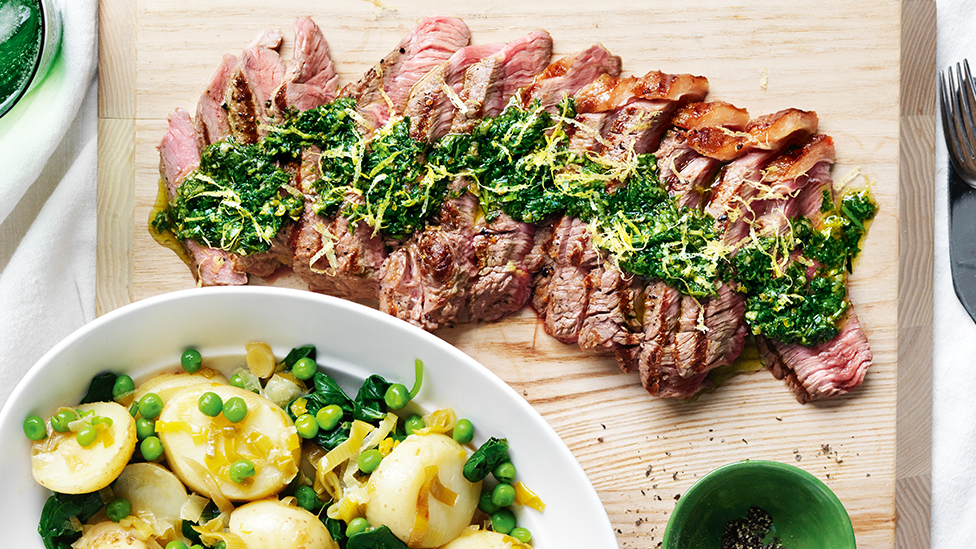 Steak with salsa verde, braised potatoes and peas