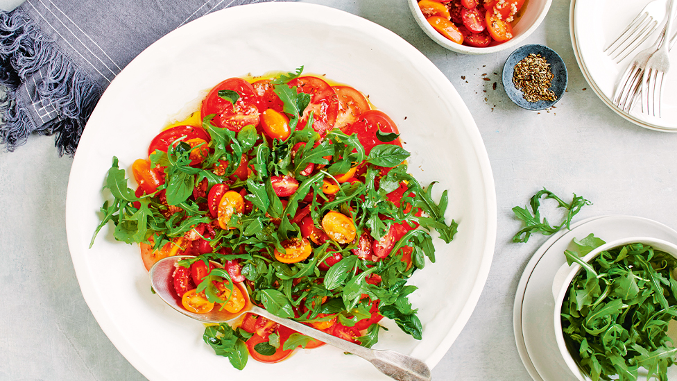 Tomato carpaccio salad with rocket and tomato-fennel seed seed vinaigrette