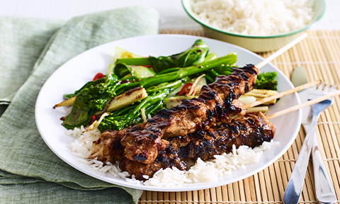 Honey and soy chicken skewers with stir-fried Asian greens