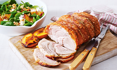 Roast pork with peaches, spinach, hazelnut and goat's cheese salad