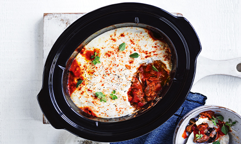 Slow-cooked Beef Moussaka in serving dish with Oregano sprigs