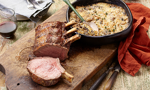 Slow-roasted standing beef rib with potato-mushroom bake
