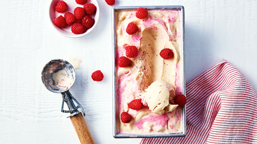 One scoop of banana and berry swirl frozen yoghurt, garnished with Coles fresh raspberries.