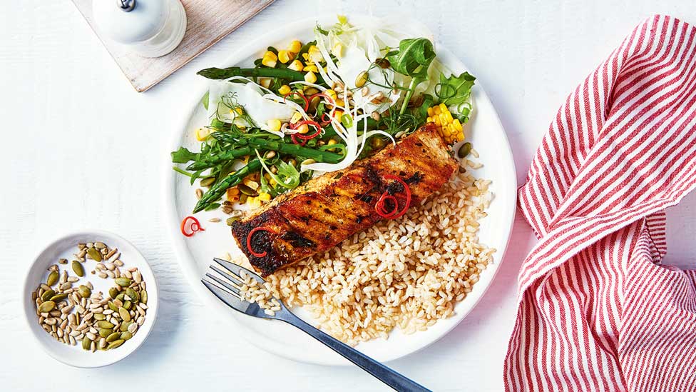 One serve of chargrilled barramundi with fennel and asparagus salad, and mixed seeds on the side.