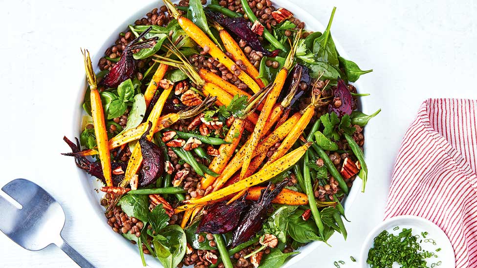 Fresh lentil, carrot and beetroot salad with chives on the side.