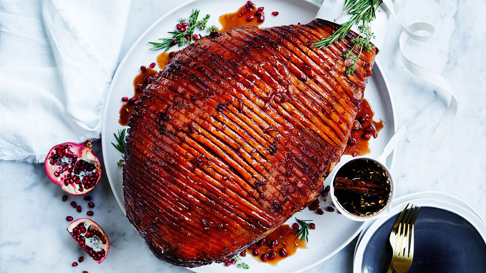 Pomegranate and cinnamon glazed ham with thyme sprigs