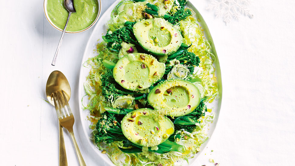Avocado and shaved brussels sprouts salad with a bunch of broccolini