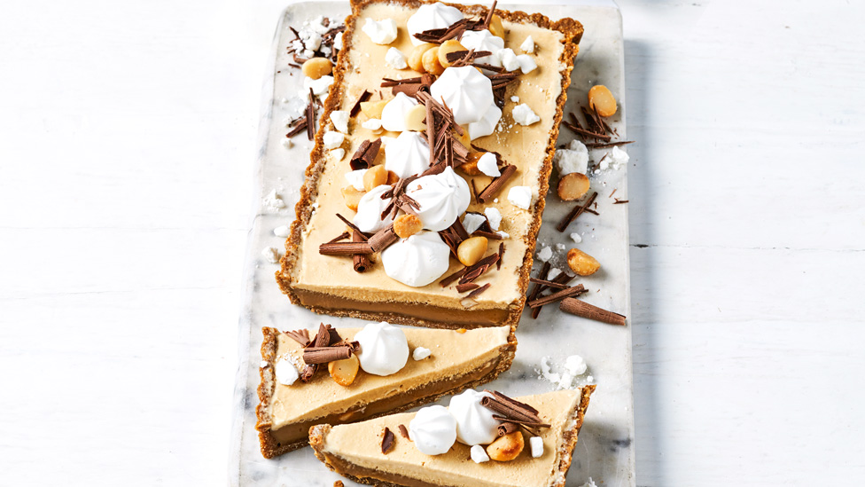 Caramel and macadamia ice cream tart topped with chocolate curls