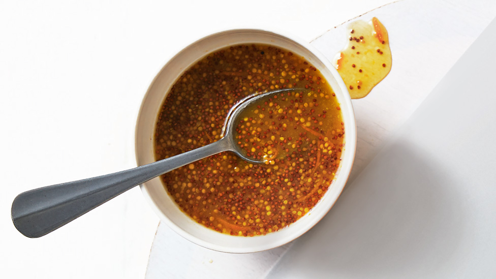 Michael Weldon’s marmalade and mustard ham glaze in a bowl, with a serving spoon.