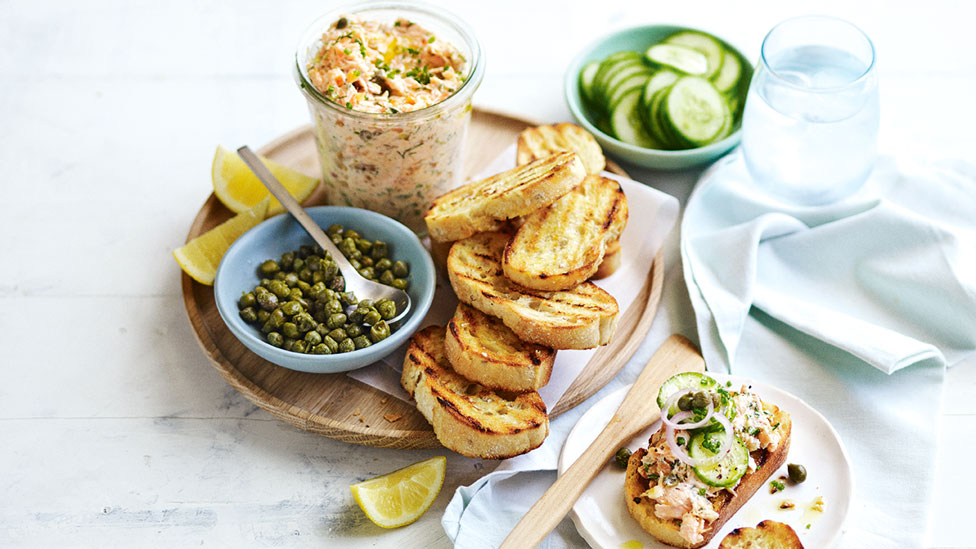 A stack of salmon rilletes served with lime and capers