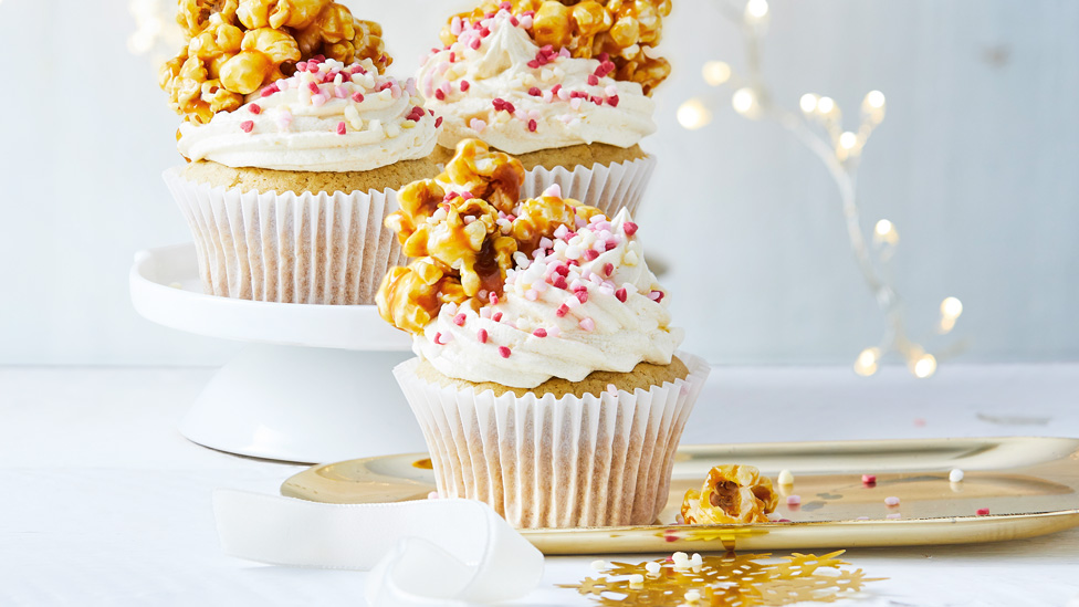 Three vegan cupcakes with caramel popcorn on top