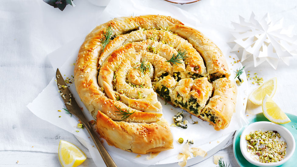 Vegan spinach filo scroll in wedges with chopped pistachio