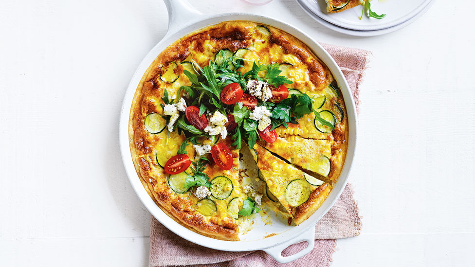 Zucchini and corn frittat with feta, rocket and tomatoes on top