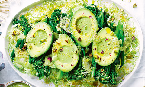 Avocado and shaved brussels sprouts salad with a bunch of broccolini