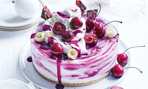 Cherry ripe cheesecake topped with chocolate bar and whipped cream