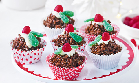 Six chocolate crackle puddings decorated with raspberries and mint leaf lollies