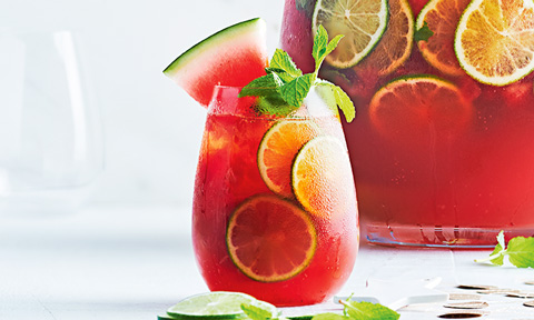Watermelon and lime caipiroska punch with mint and watermelon wedges