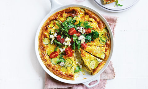 Zucchini and corn frittat with feta, rocket and tomatoes on top
