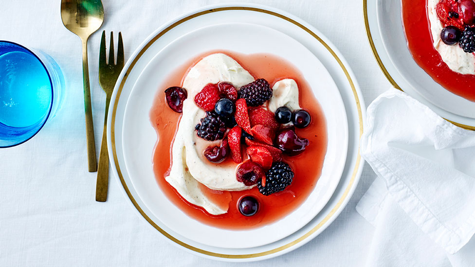 A bowl of berries poached in balsamic vinegar with crème fraîche chantilly