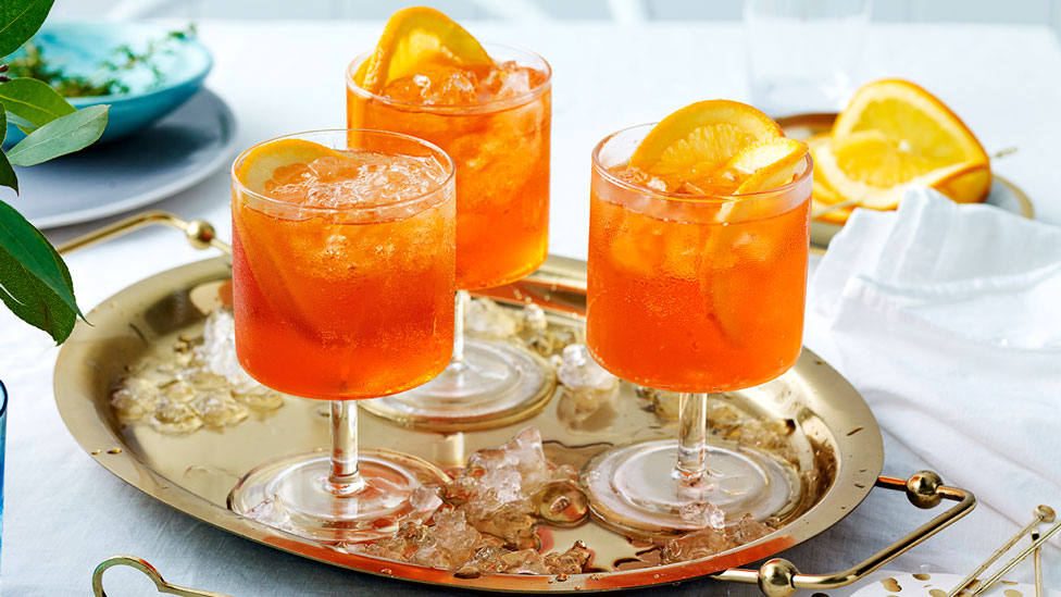 3 glasses of aperol spritz with orange peel