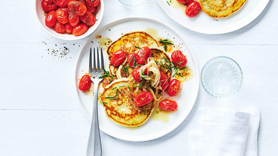 Herbed buttermilk pancakes topped with burst tomatoes 