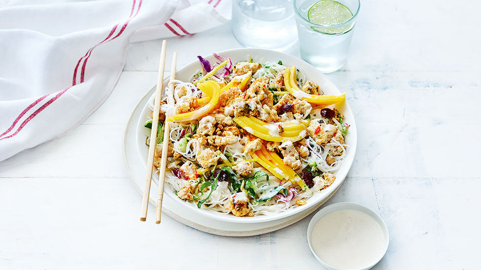 Mango and chicken noodle salad served on a dish