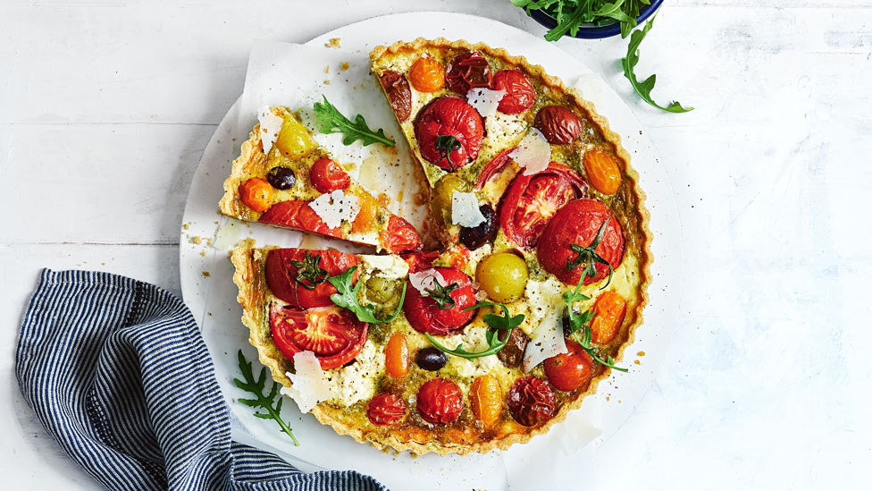 Wholemeal mixed tomato quiche cut into wedges
