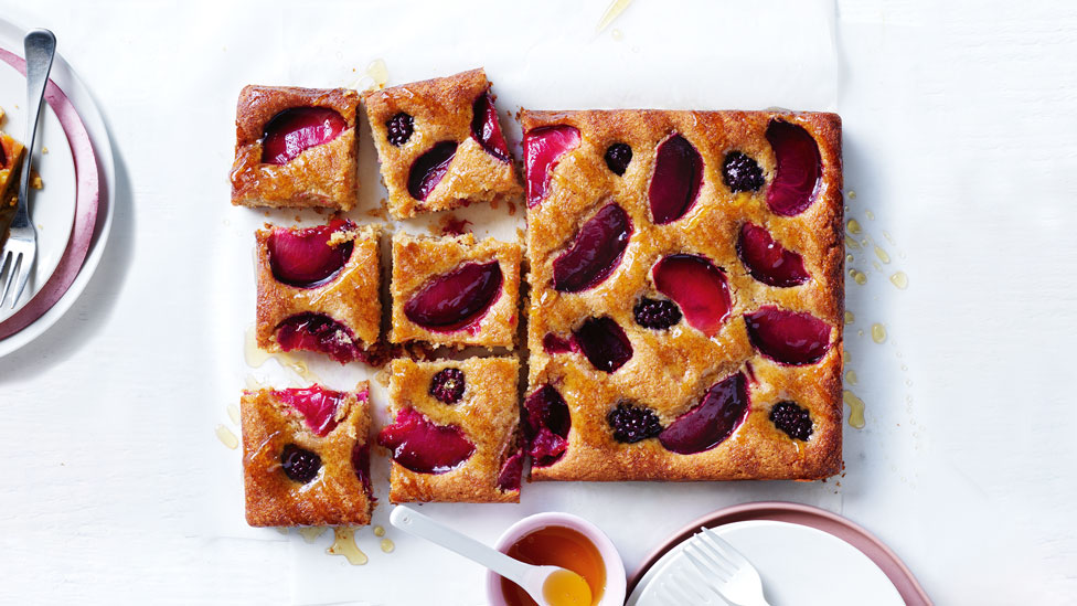 A plum and blackberry honey cake cut into squares