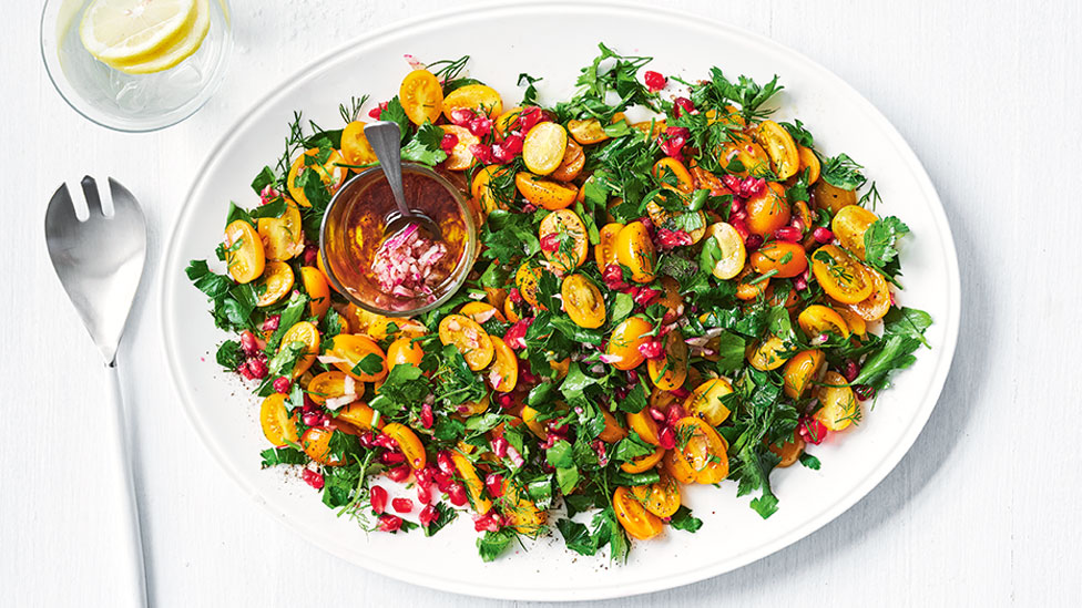 A golden tomato and pomegranate salad with maple syrup dressing