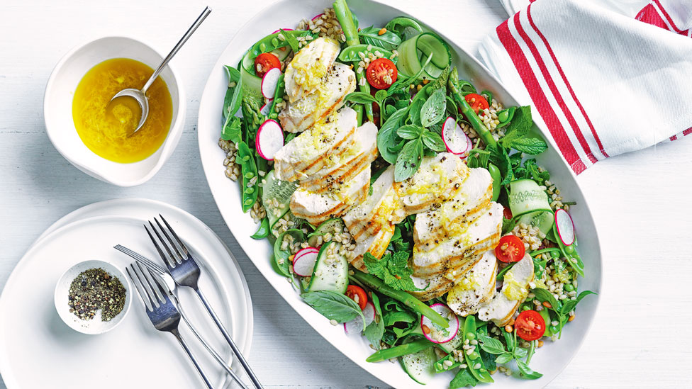 Thickly sliced grilled chicken breast with herb barley salad