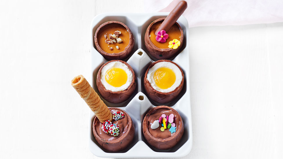 Six DIY filled Easter eggs topped with wafer rolls